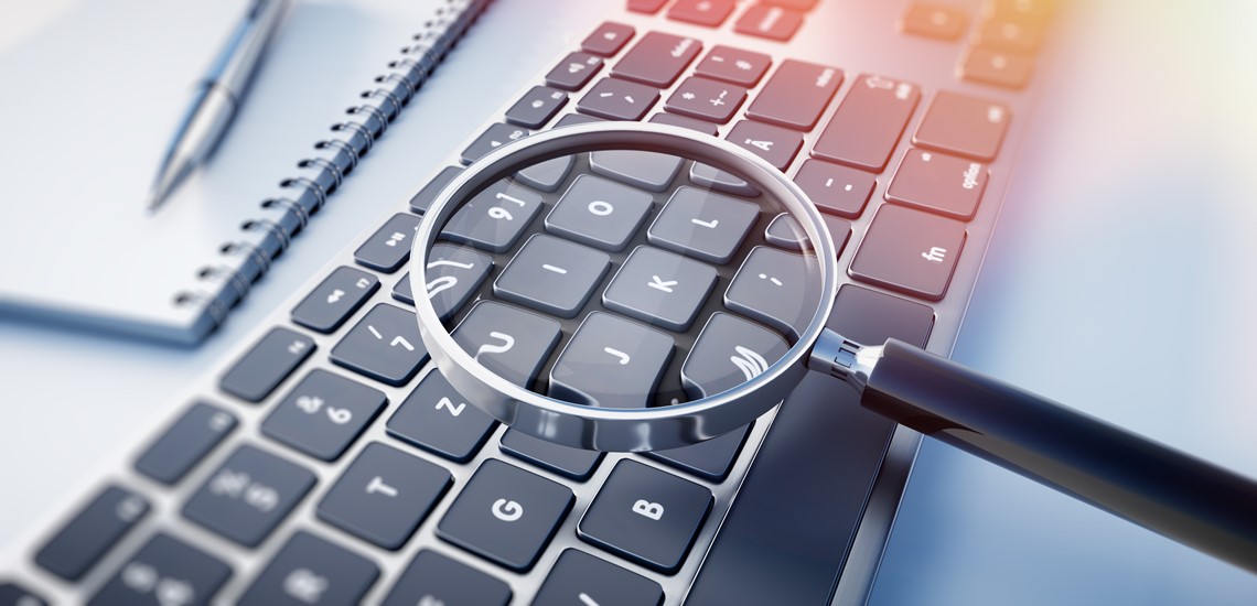 A magnifying glass over a keyboard